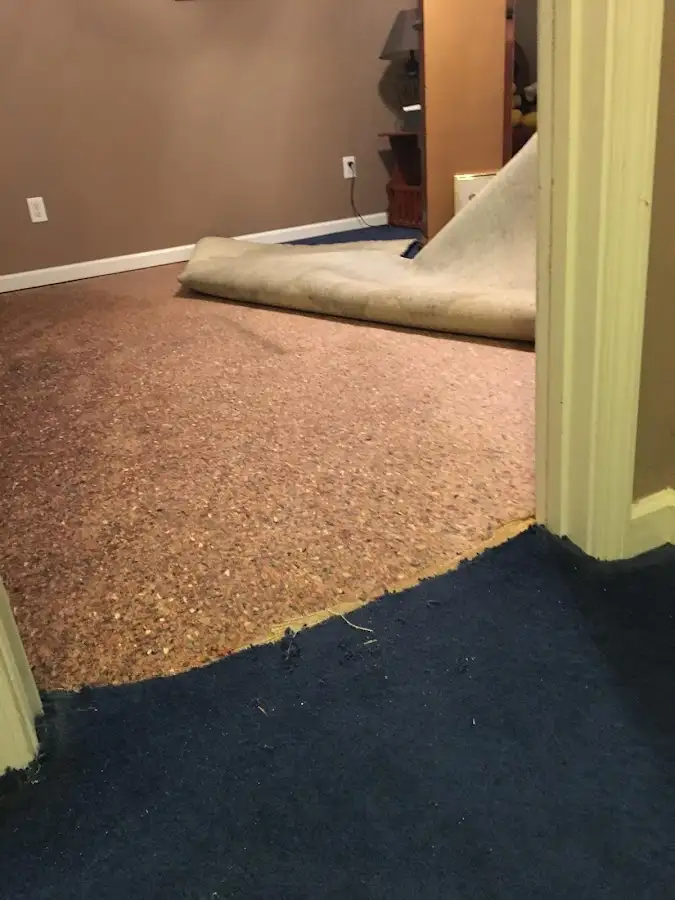 Carpet pad removal revealing water damage during Water Mitigation Services in Seagoville
